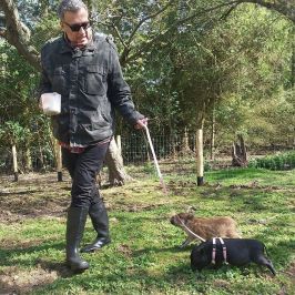 a man standing next to a tree