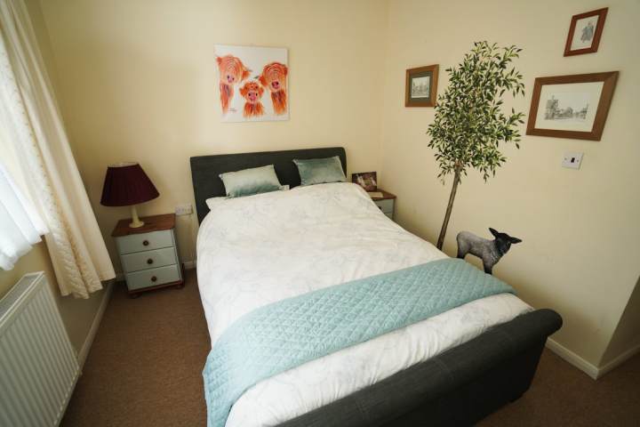 a bedroom with a bed and desk in a small room