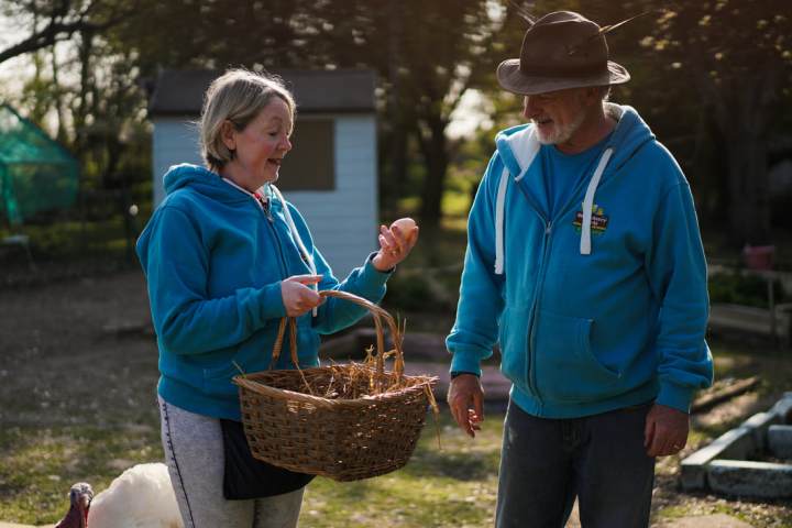 a couple of people that are standing in the grass