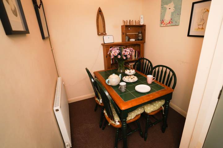 a bedroom with a bed and a chair in a room