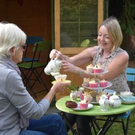 a woman sitting at a table with a cake