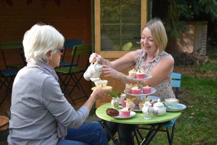 a woman sitting at a table with a cake