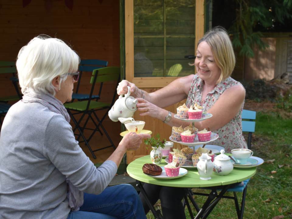 dsc-0062_orig a woman sitting at a table with a cake