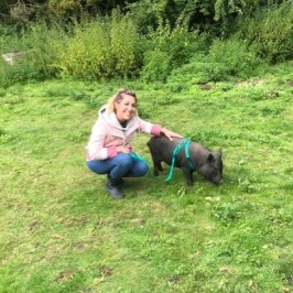 a person holding a baby in a green field