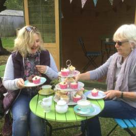 a person sitting at a table with a birthday cake