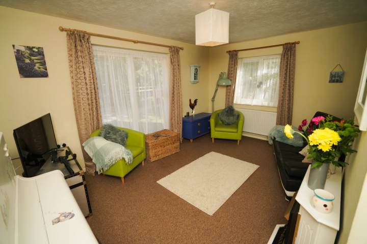 a living room filled with furniture and a mirror