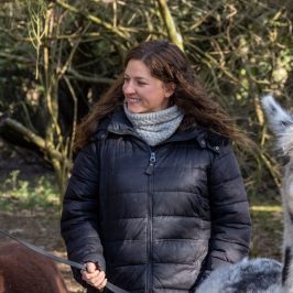 a woman holding a dog