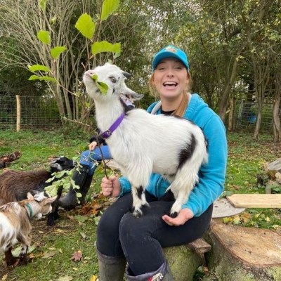a person holding a dog in a garden