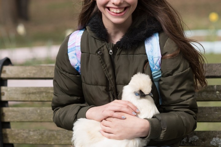 a woman sitting on a park bench