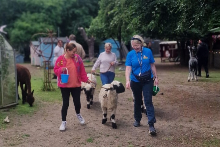 a group of people walking down a dirt road